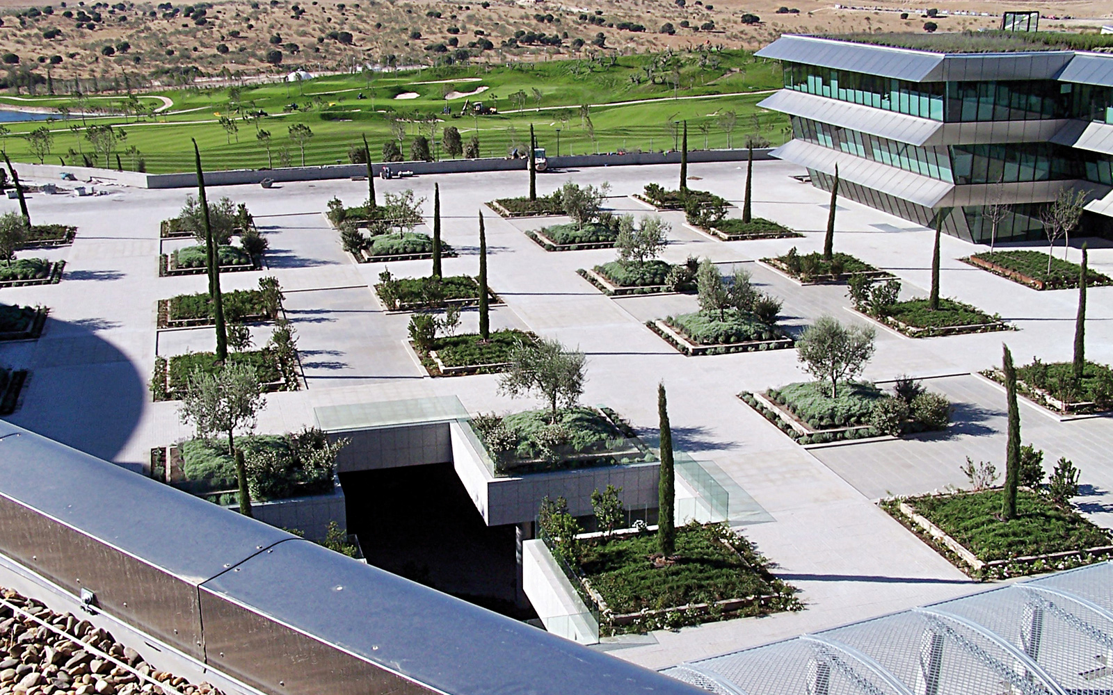 Large planting beds with trees above the two storied underground garage. Green roof with trees and walkways